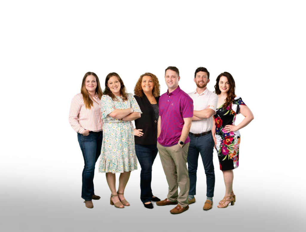 A group of people standing together in front of a white background